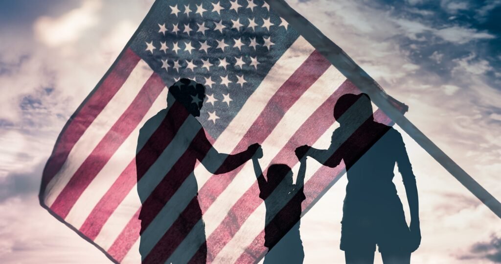 Silhouette of a family against an American flag