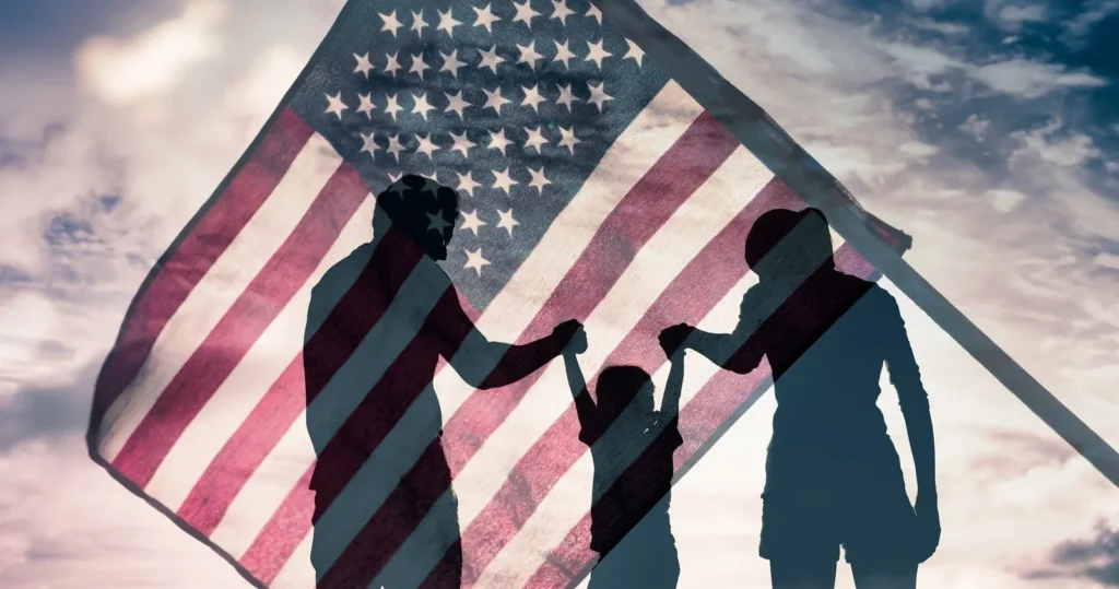 Silhouette of a family against an American flag
